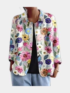Open blouse with painted daisies and anemones on cream, worn over a black top