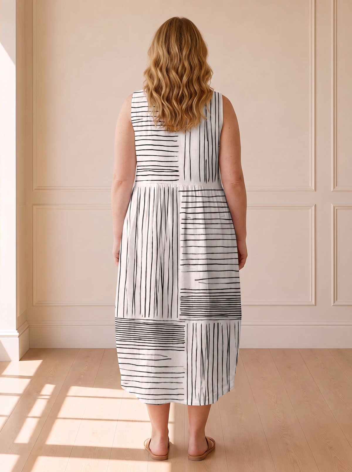 The Amara midi dress in black and white line print, back view