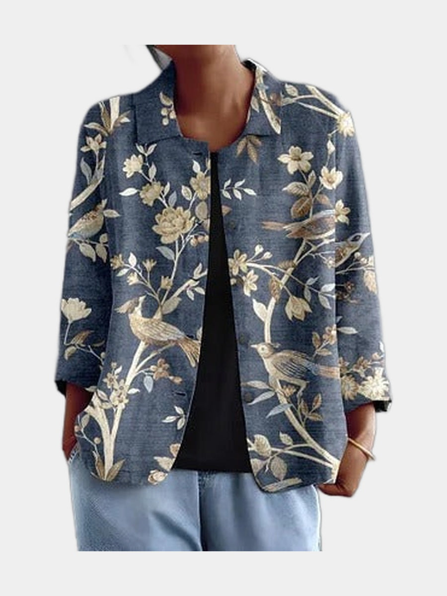 Open blouse in blue with cream birds and branches, worn over a black top