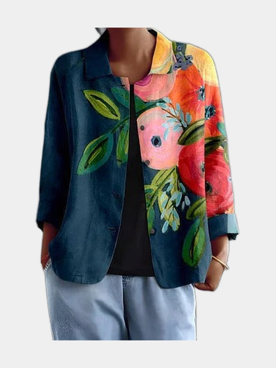 Deep teal open shirt with painted poppies placed across one side, worn over a black top