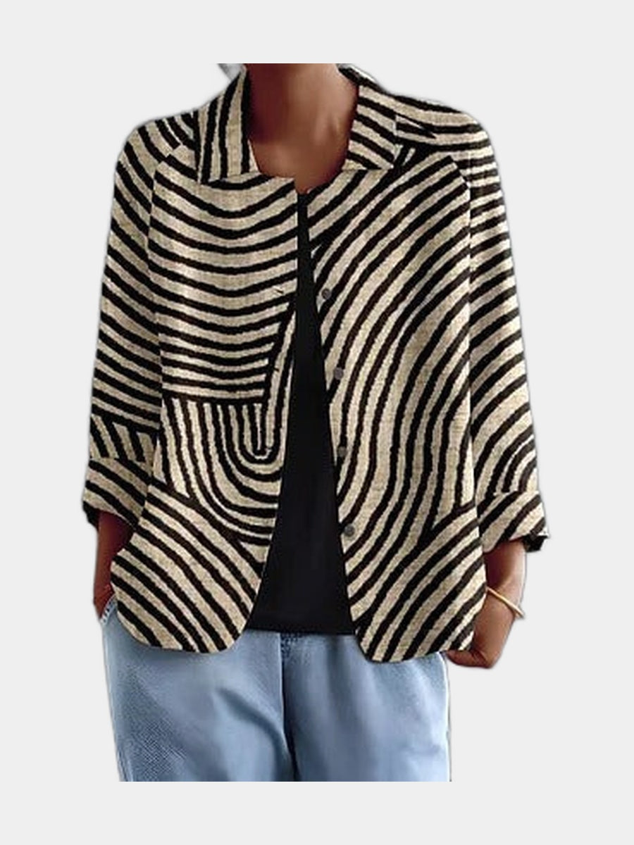 Open blouse with black and cream curved stripes, worn over a black top