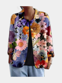 Open blouse in a dense pressed-flower print on a dark ground, worn over a black top