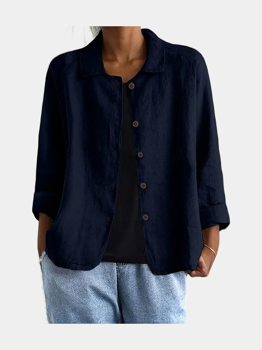 Open blouse in navy with a fine even weave and curved hem, worn over a black top