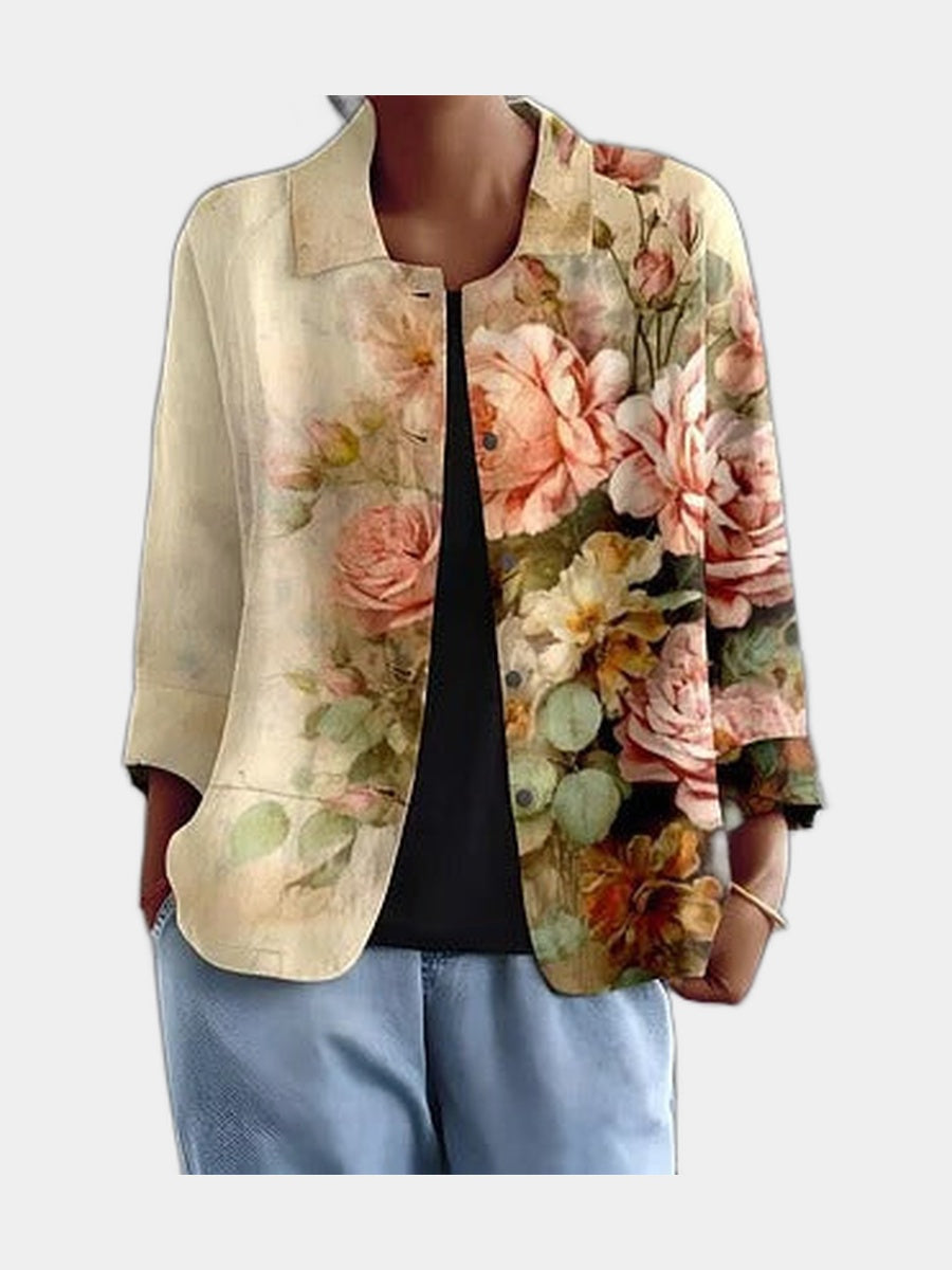 Open blouse with painted apricot and sage roses gathered on one side, worn over a black top