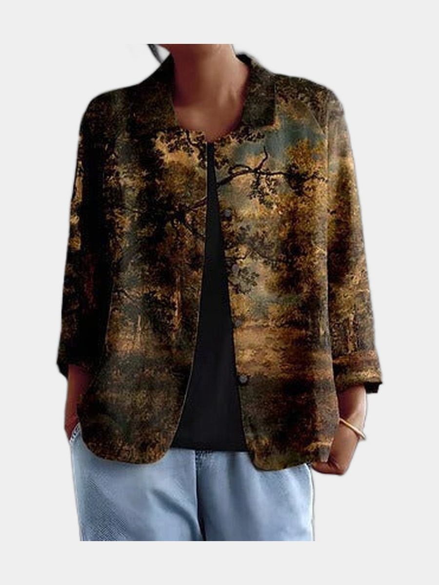 Open blouse printed with a dark painterly landscape of trees in bronze, olive and gold, worn over a black top