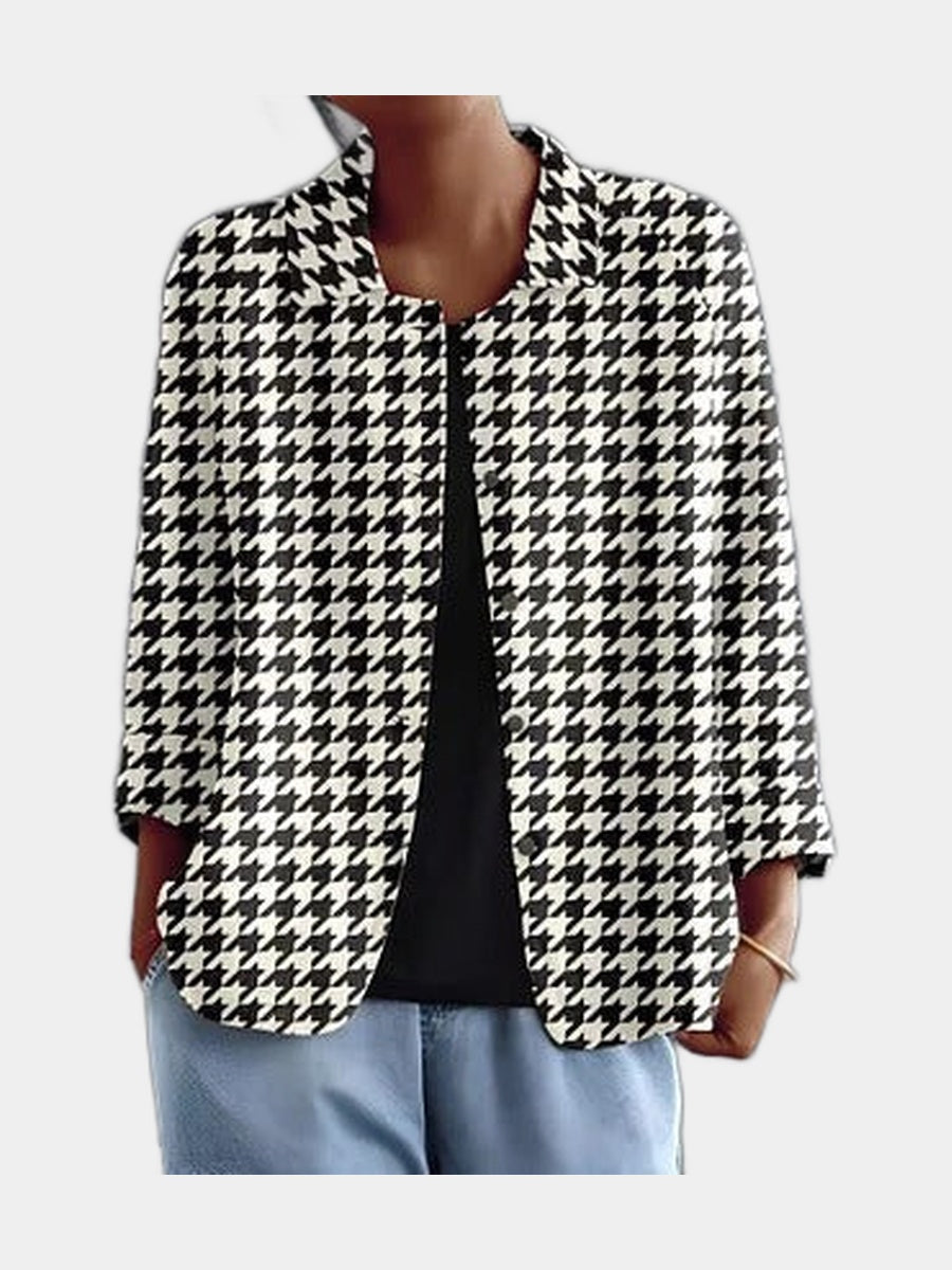 Open blouse in black and white houndstooth, worn over a black top