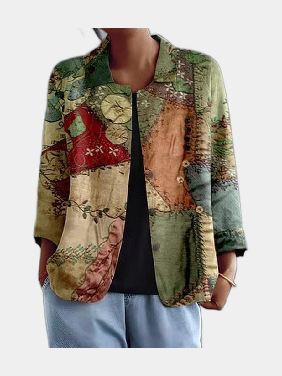 Open blouse in a printed patchwork of faded green, rust and cream, worn over a black top