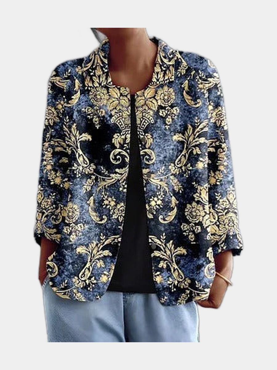 Open blouse with gold baroque scrollwork on deep indigo, worn over a black top