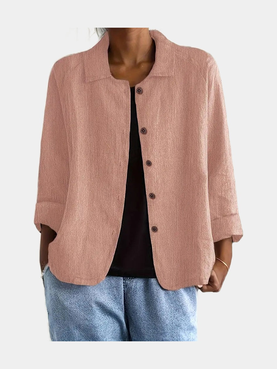 Open blouse in clay pink with a finely crinkled matte surface, worn over a black top