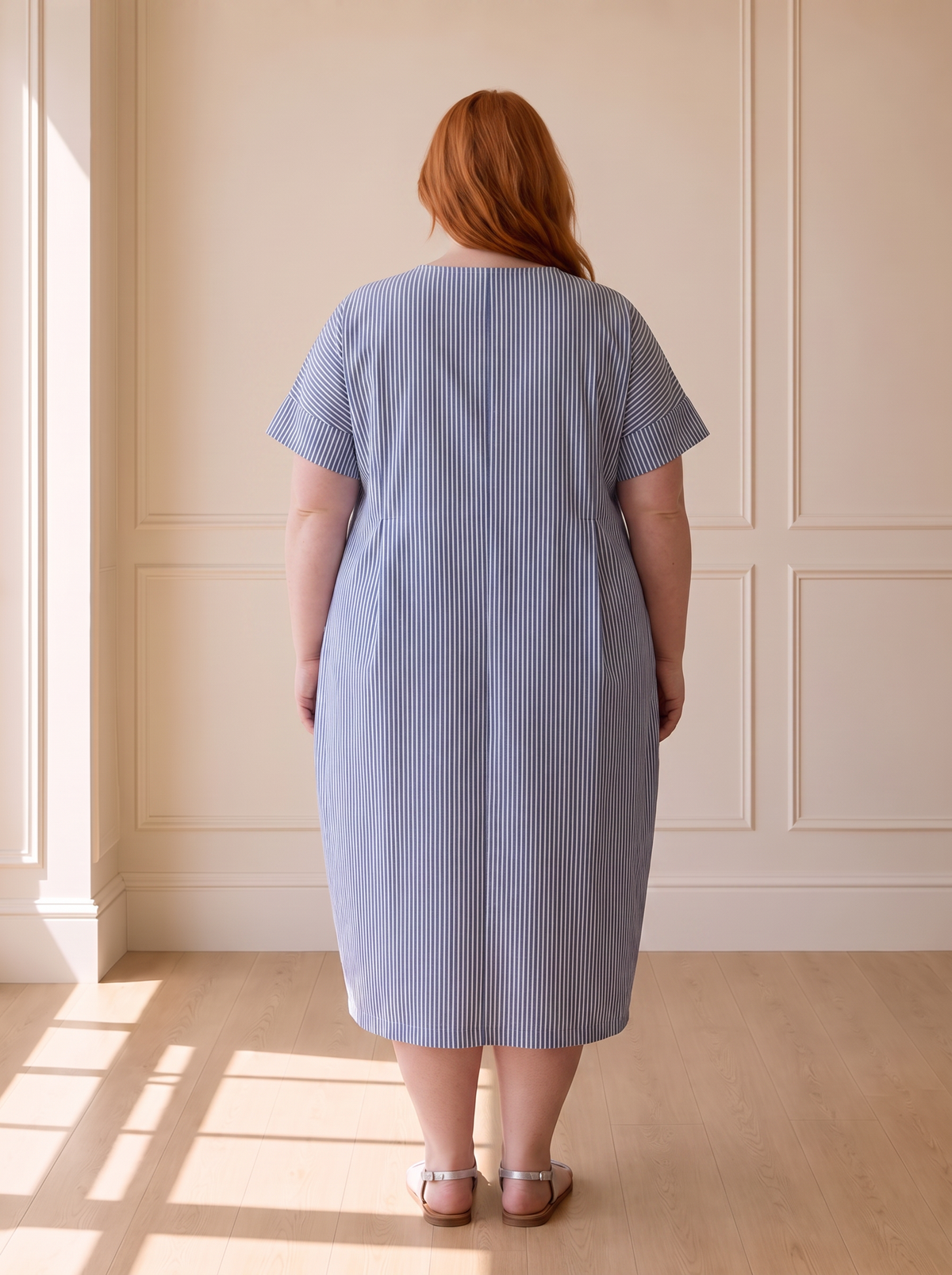 Susana striped cocoon midi dress in blue, back view, worn by a plus-size model