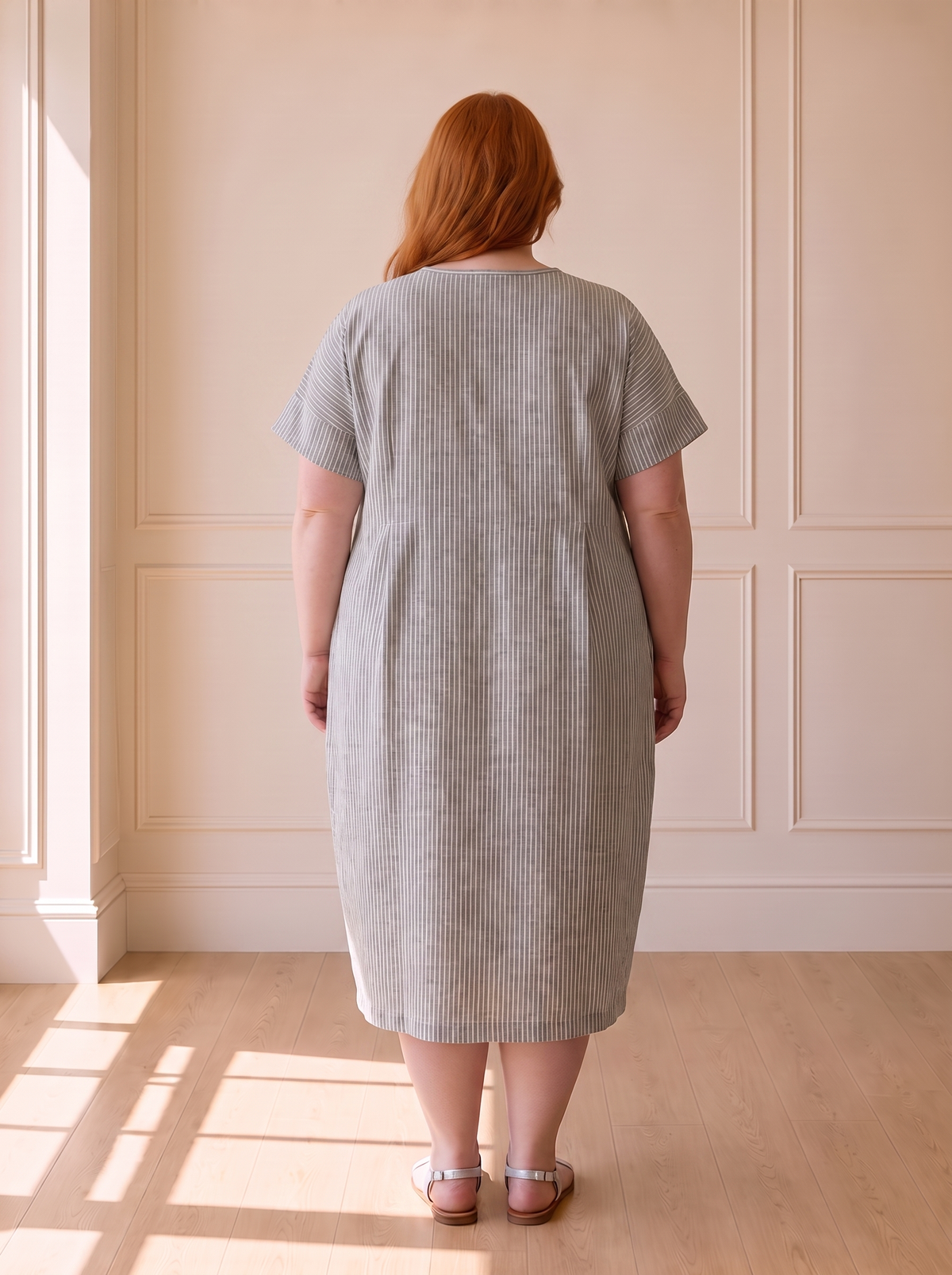 Susana striped cocoon midi dress in grey, back view, worn by a plus-size model