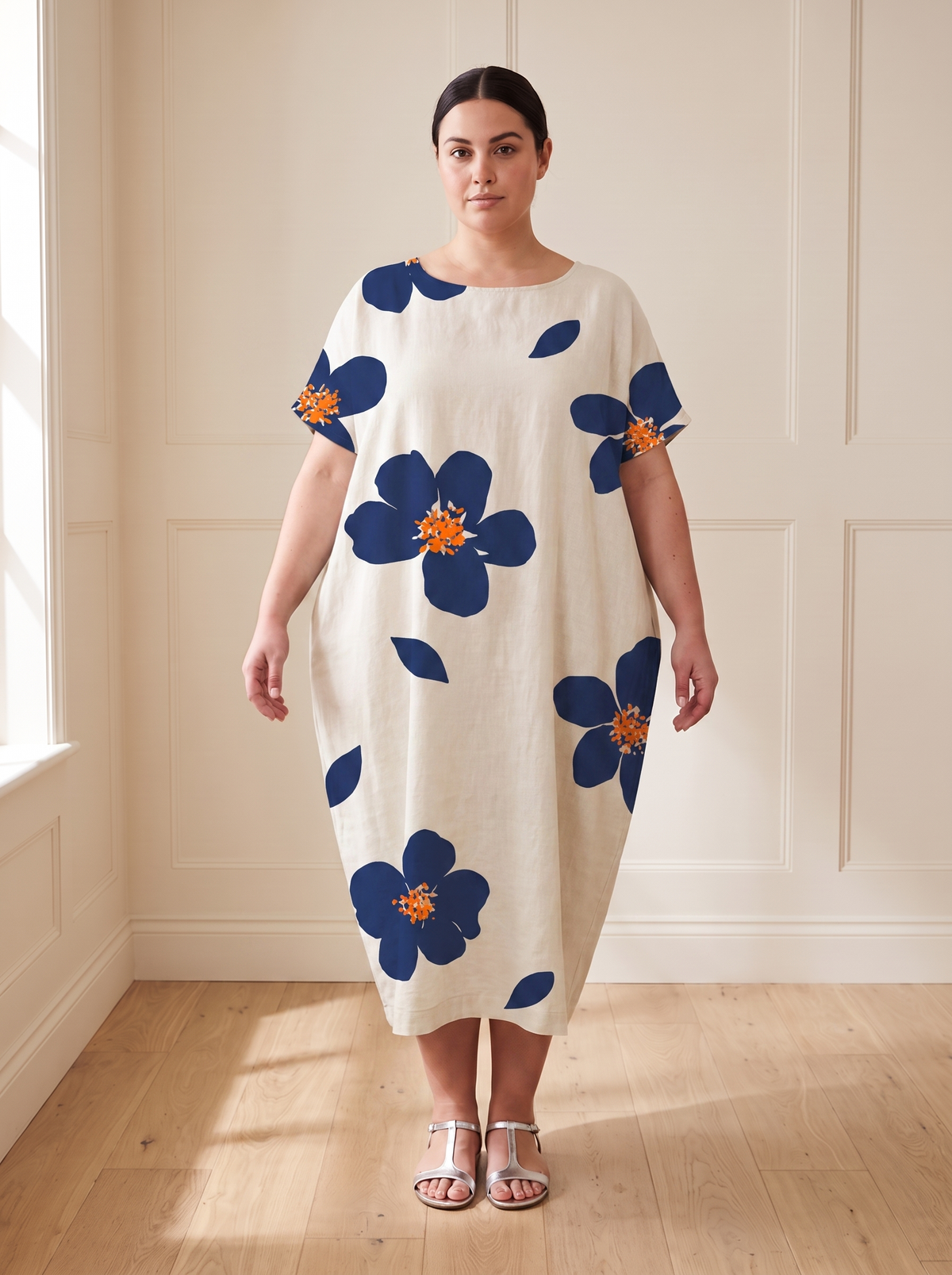 Lilia floral cocoon midi dress in blue, front view, worn by a plus-size model