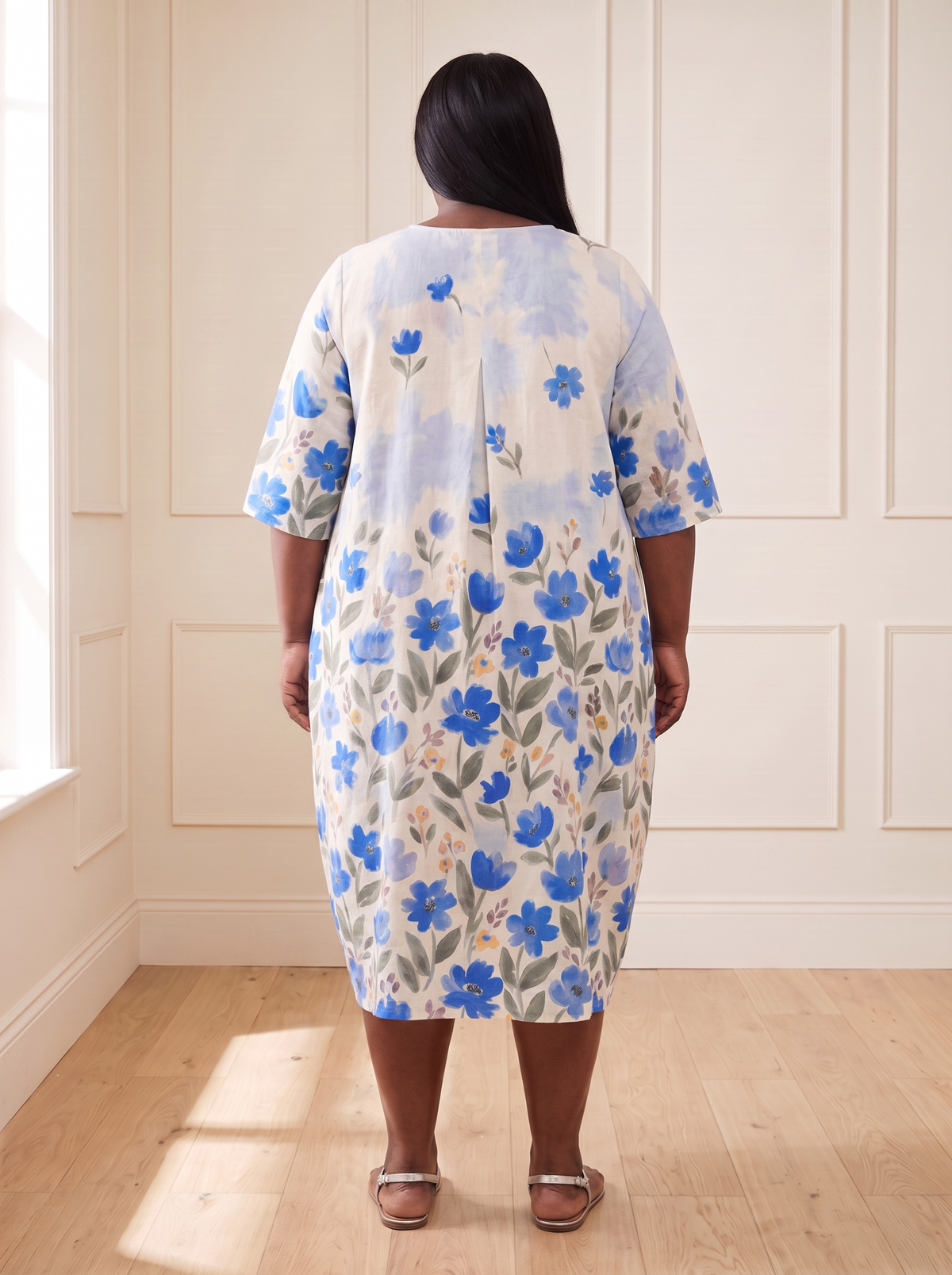 Leila floral cocoon midi dress in blue, back view, worn by a plus-size model