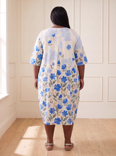 Leila floral cocoon midi dress in blue, back view, worn by a plus-size model