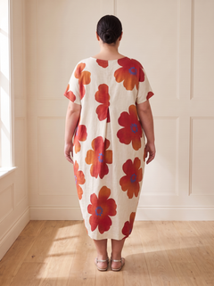 Lilia floral cocoon midi dress in red, back view, worn by a plus-size model