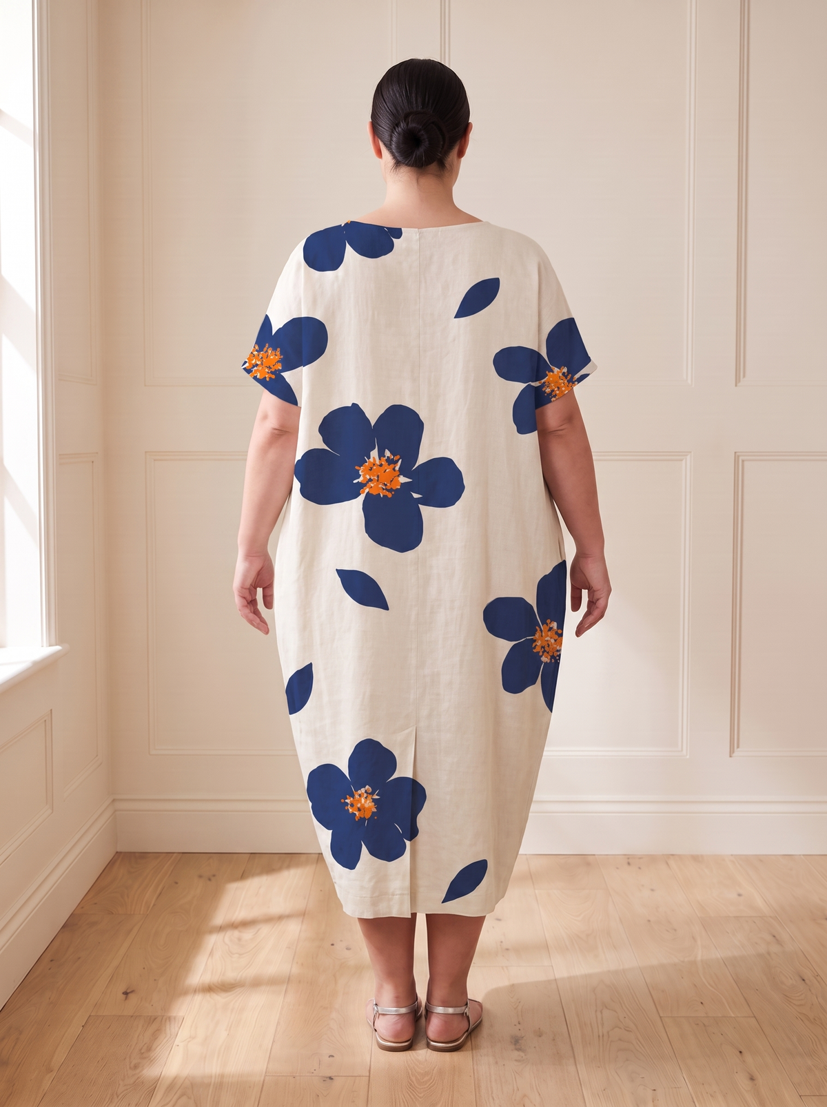 Lilia floral cocoon midi dress in blue, back view, worn by a plus-size model