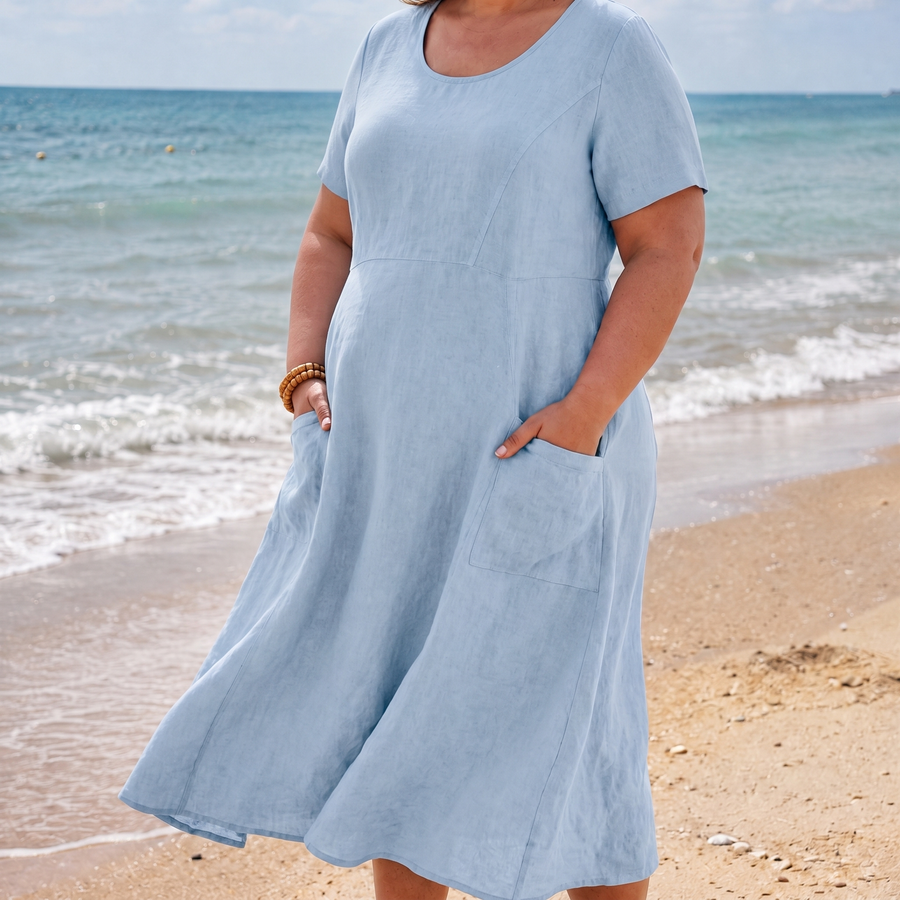 Maya pocket dress in blue on the beach